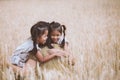 Asian child girls hugging their mother and having fun to play with mother in the barley field in vintage color tone Royalty Free Stock Photo