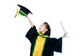 Asian child in graduation gown smiling and holding diploma certificate.