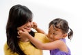 Asian Child Happy Playing Pinch Cheek with Teen Sister Royalty Free Stock Photo