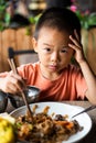 Asian child having lunch at the restaurant Royalty Free Stock Photo