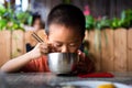 Asian child having lunch at the restaurant