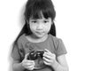 Asian child is holding alarm clock, black and white Royalty Free Stock Photo