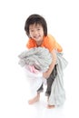 Asian child holding stack of t-shirts Royalty Free Stock Photo