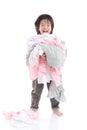 Asian child holding stack of t-shirts Royalty Free Stock Photo