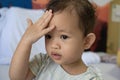 Asian child keeps a hand for a head Royalty Free Stock Photo