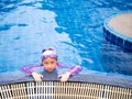 Asian child or kid girl wearing swimming suit to learning on swimming pool , learn and training swim on kick board Royalty Free Stock Photo