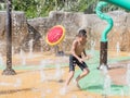 Asian child little boy having fun to play with water in park fountain in summer time Royalty Free Stock Photo