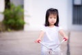 Asian child little girl is riding a bicycle on the road. Children ride a tricycle exercise bike. Royalty Free Stock Photo