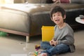 Asian child playing with colorful construction blocks