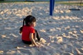 Asian child playing with sand in the playground Royalty Free Stock Photo