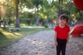 Asian child playing with sand in the playground Royalty Free Stock Photo