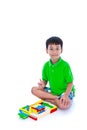 Asian child playing toy wood blocks, isolated on white background. Royalty Free Stock Photo