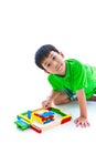 Asian child playing toy wood blocks, isolated on white background. Royalty Free Stock Photo