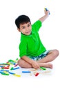 Asian child playing toy wood blocks, isolated on white background. Royalty Free Stock Photo