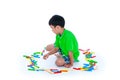 Asian child playing toy wood blocks, isolated on white background. Royalty Free Stock Photo