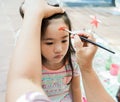 asian Child preschooler with face painting. Make up.