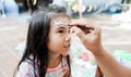 asian Child preschooler with face painting. Make up.