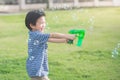 Asian child Shooting Bubbles from Bubble Gun Royalty Free Stock Photo
