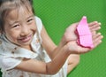 Asian child shows her origami paper craft