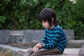 asian child sitting in the park Royalty Free Stock Photo