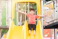 Asian child smiling playing on slider bar toy outdoor playground, happy preschool little kid having funny while playing Royalty Free Stock Photo