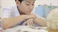 Asian child in student uniform to do homework at home. Royalty Free Stock Photo