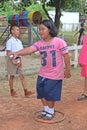 Asian child is throwing petanque ball.