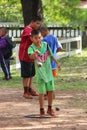 Asian child is throwing petanque ball.