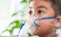 Asian Child using nebulizer mask equipment alone have smoke