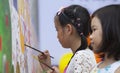 Asian children drawing images and writing their wishes