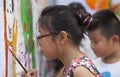 Asian children drawing images and writing their wishes