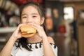 Asian Children eat chicken cheese Hamburger Food Court