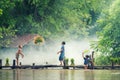 Asian children farmer on rice cross the wood bridge before the grown in paddy field Royalty Free Stock Photo