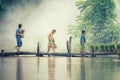 Asian children farmer on rice cross the wood bridge before the grown in paddy field Royalty Free Stock Photo