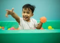 Asian children happiness emotion playing in color ball pool