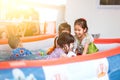 Asian children having fun to play water and swimming in the pool Royalty Free Stock Photo