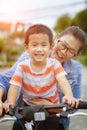 Asian children and mother happiness emotion riding bicycle in home village