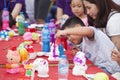 Asian children painting and writing their wishes on wishing cards