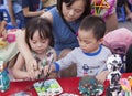 Asian children painting and writing their wishes on wishing cards