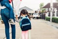 Asian children piggyback and walking with mother outdoors, the mother