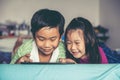 Asian children watching video and playing game on digital tablet Royalty Free Stock Photo