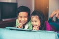 Asian children watching video and playing game on digital tablet Royalty Free Stock Photo