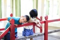 Asian children playing on red wooden bridge. Royalty Free Stock Photo