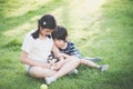 Asian children playing with siberian husky puppy Royalty Free Stock Photo