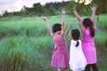 Asian children raise hands and playing together