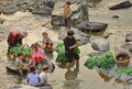 Asian with children, washed greens in a rural river.