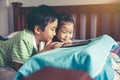 Asian children watching video and playing game on digital tablet Royalty Free Stock Photo