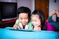 Asian children watching video and playing game on digital tablet Royalty Free Stock Photo