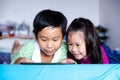 Asian children watching video and playing game on digital tablet Royalty Free Stock Photo