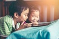 Asian children watching video and playing game on digital tablet Royalty Free Stock Photo